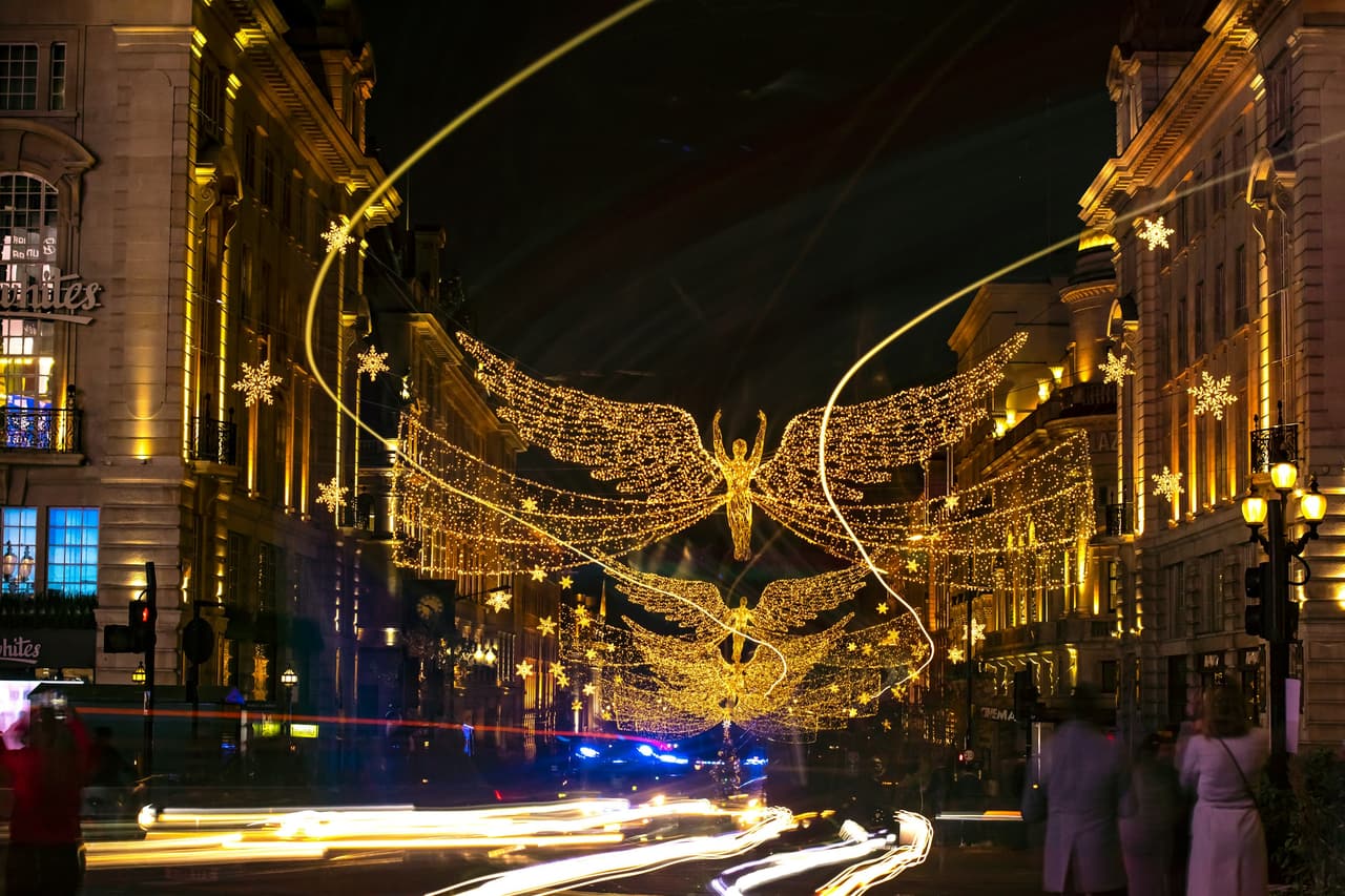 Christmas lights strung across a London street at night